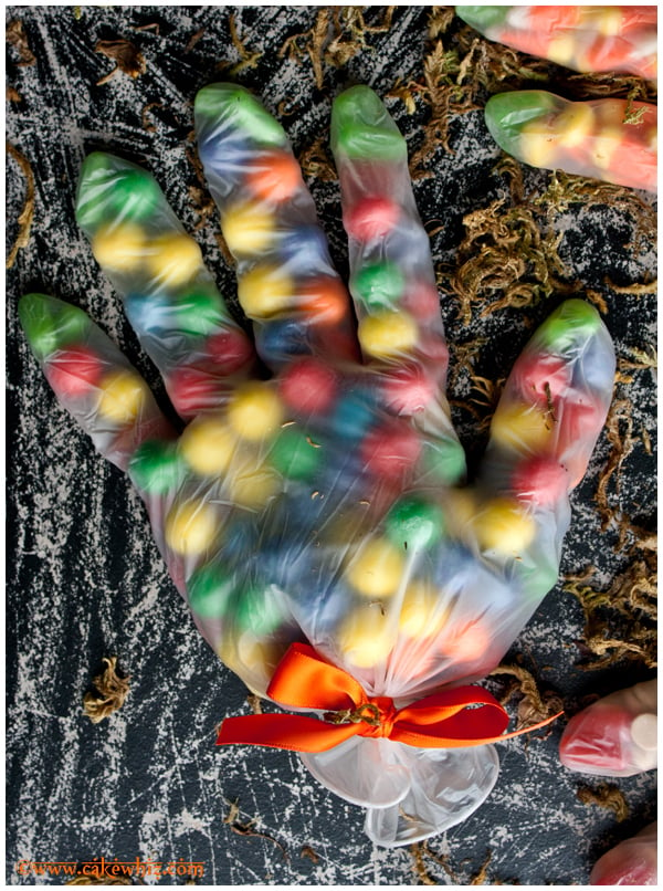 Easy Halloween Treat Bags With Candies in Gloves on Rustic Black Background