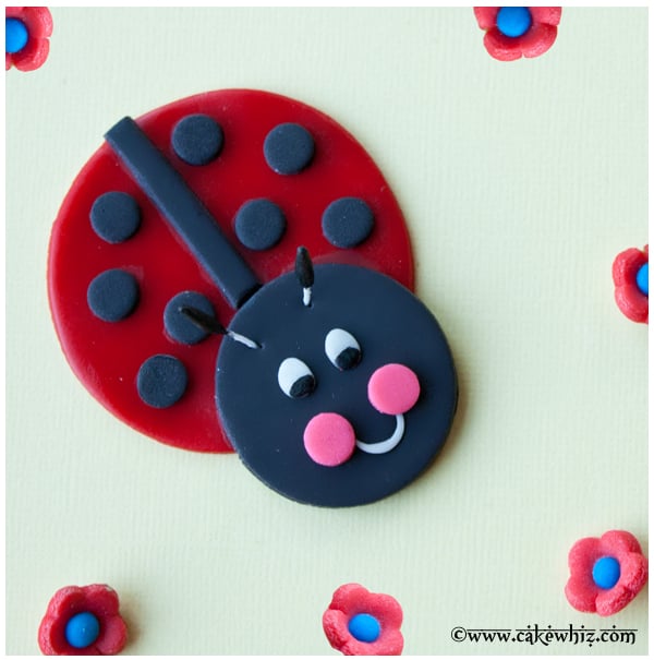 Fondant Ladybug Cupcake Topper on Yellow Background