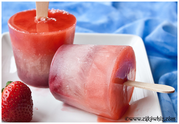 Easy Homemade Fruit Popsicles on White Plate with Blue Background 