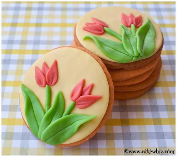 Easy Decorated Tulip Cookies on a Checkered Yellow and Gray Background