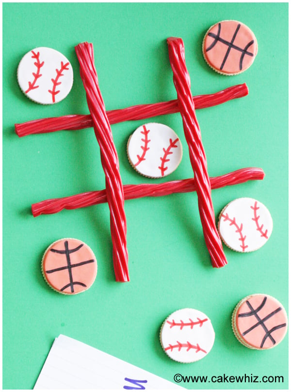 Edible Tic Tac Toe Game with Candies and Cookies on Green Background