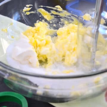 Ingredients being mixed together in a glass bowl. 