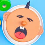 Easy Baby Cake With Homemade Fondant Decoration on White Dish.
