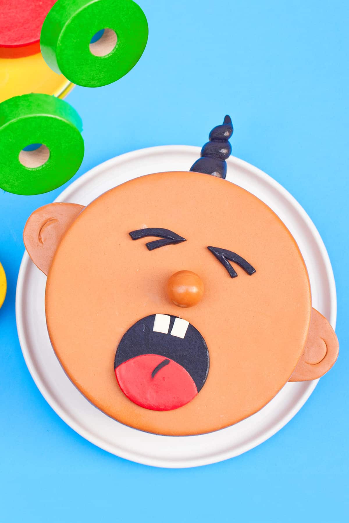 Easy Baby Cake With Fondant on White Dish and Blue Background. 