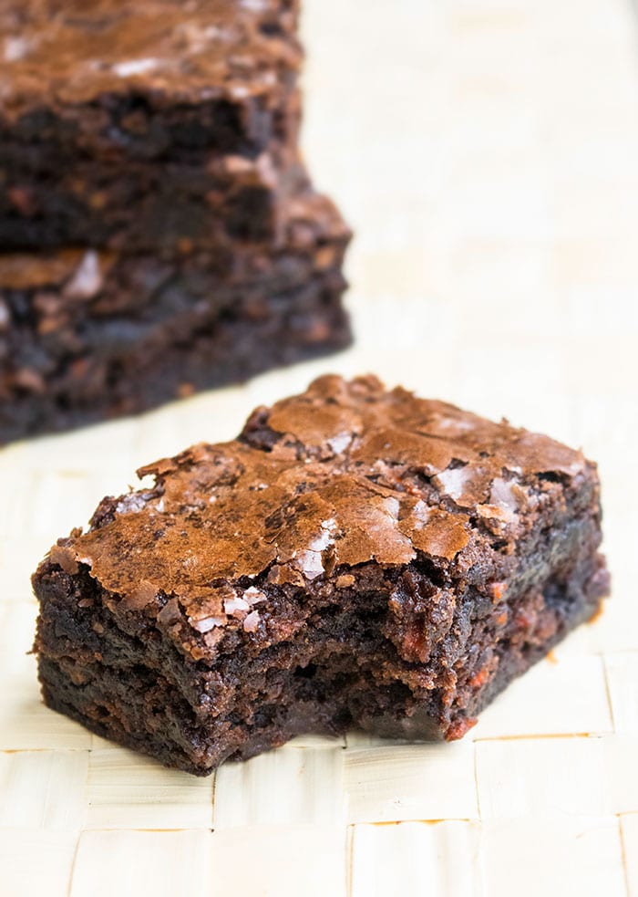 Partially Eaten Carrot Brownies on Wood Background. 