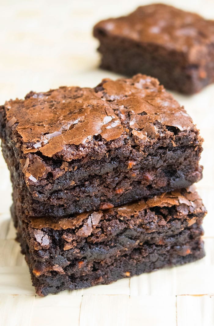 Stack of Homemade Carrot Brownies on Wood Background. 