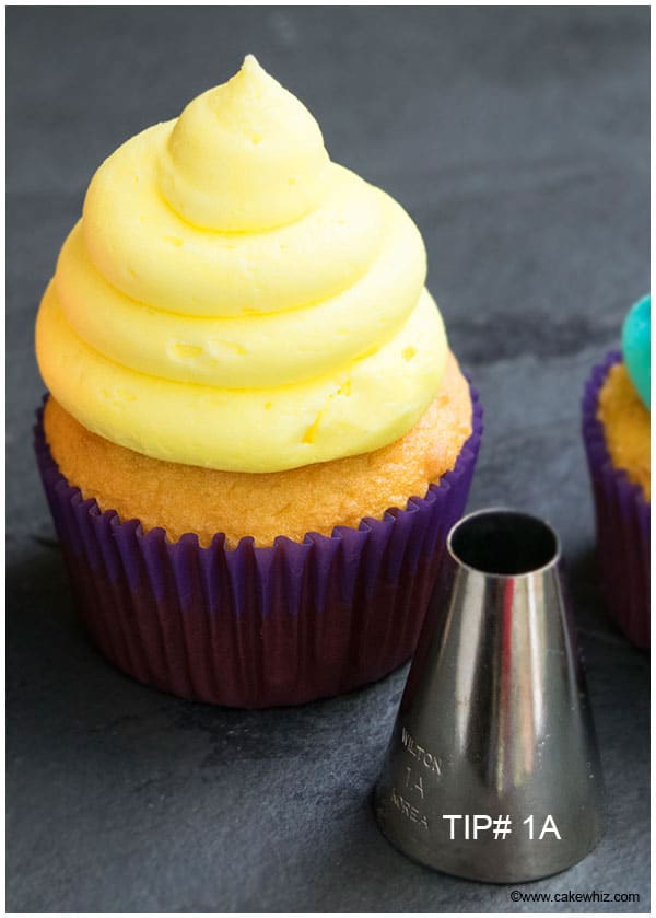 Cupcake With Yellow Buttercream Icing Swirl Made With Pastry Tip 1A on Rustic Gray Background 