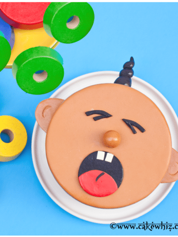 Easy Baby Cake on White Dish With Blue Background.
