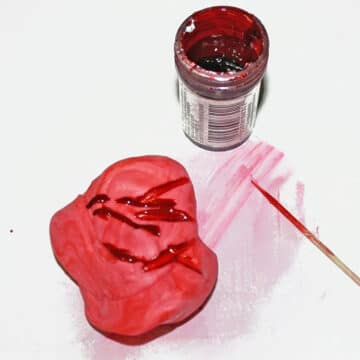 Toothpick being used to add tint to fondant. 