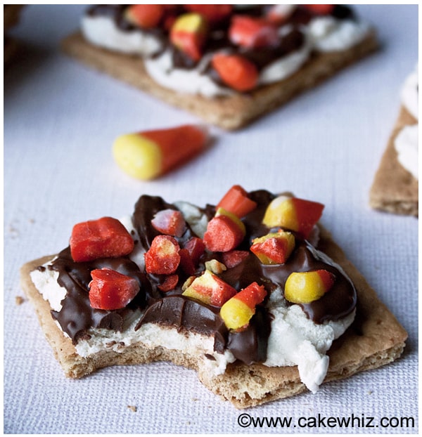 Partially Eaten Candy Corn S'mores on Pale Blue Background.