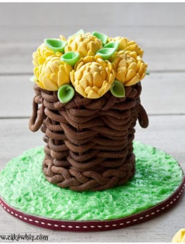 Easy Basket Cake With Fondant Flowers on Gray Background