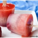 Easy Homemade Fruit Popsicles on White Plate with Blue Background