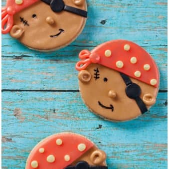 Easy Pirate Cookies Decorated With Fondant on Rustic Blue Background.