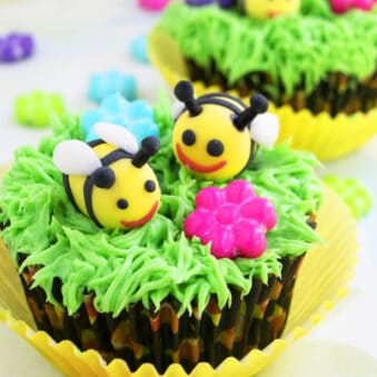 Easy Fondant Bee Cupcakes (Honey Bee or Bumblebee) With Green Grass Icing on Light Yellow Background