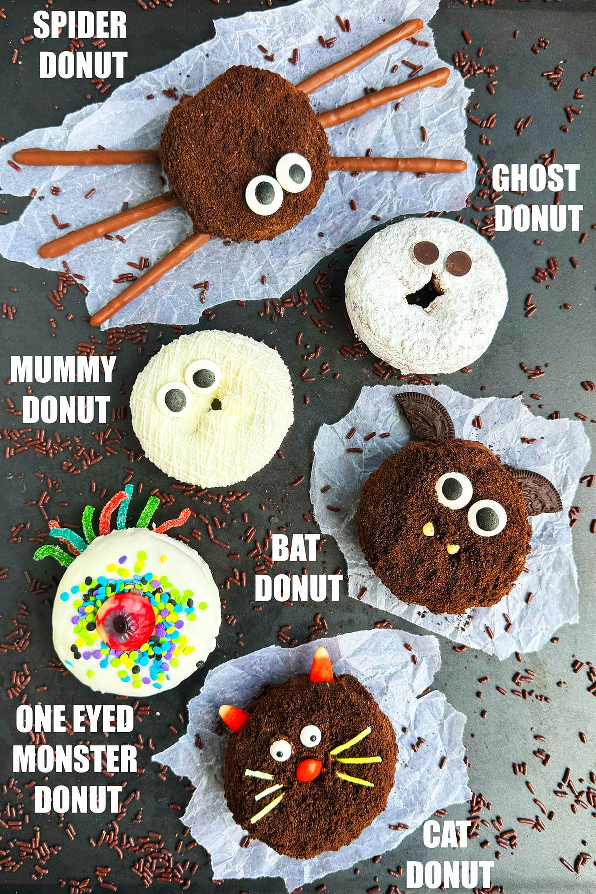 Easy Halloween Donuts (Mummy, Spider, Bat, Cat, Ghost, Monster) on Metallic Gray Background With Chocolate Sprinkles. 