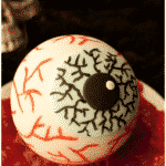 Easy Spooky Halloween Eyeball Cake on White Plate With Red Jam