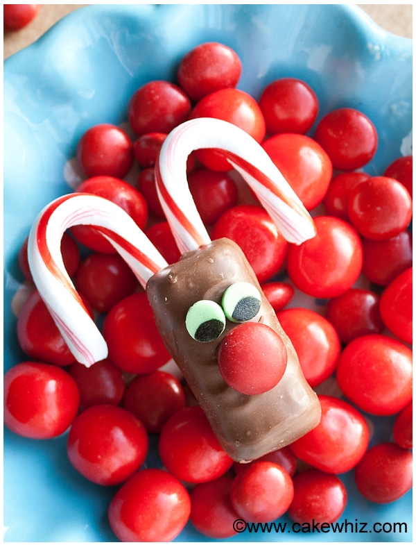 Rudolf Chocolate Bars Placed on Top of Red Candies in Blue Dish. 