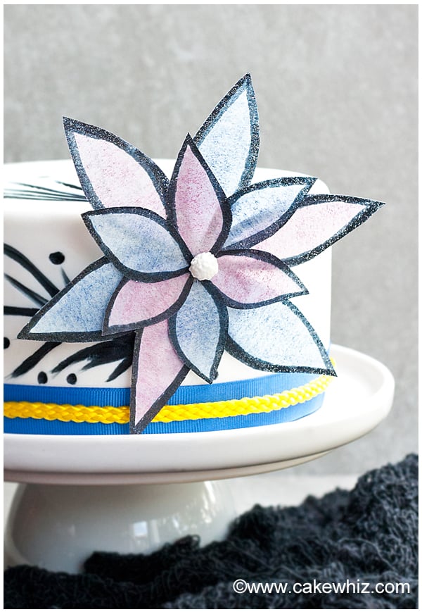 Closeup Shot of Wafer Flowers on White Cake With Gray Background