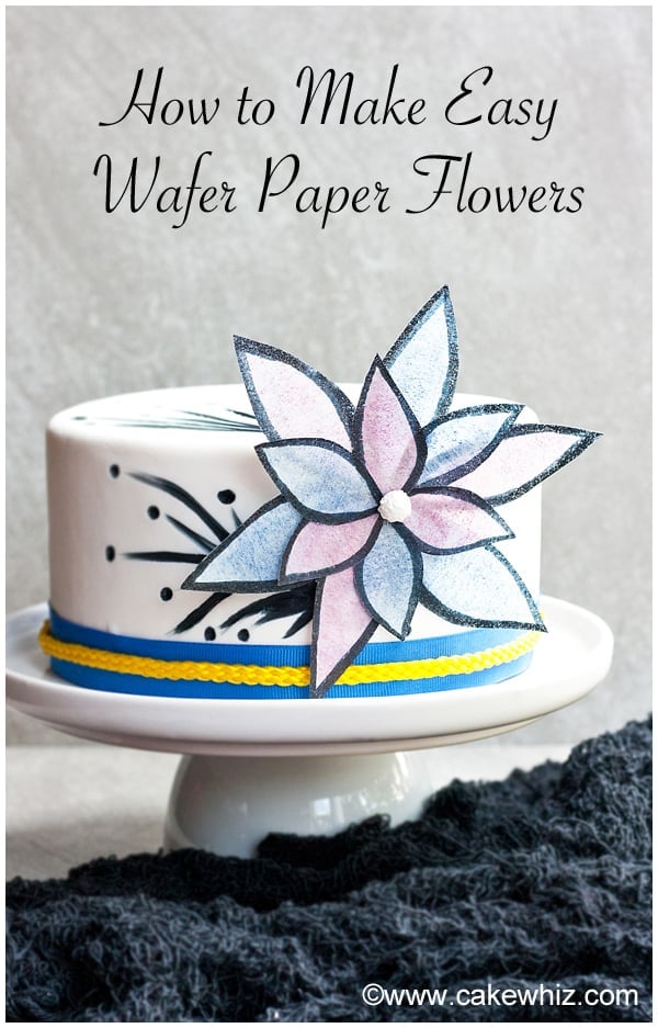 White Fondant Cake With Easy Wafer Paper Flowers on Gray Background