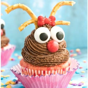 Easy Reindeer Cupcakes For Christmas With Blue Background and Sprinkles Scattered Everywhere