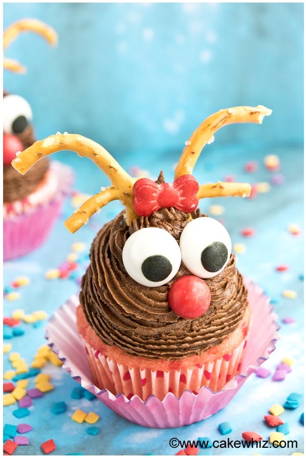 Easy Reindeer Cupcakes For Christmas With Blue Background and Sprinkles Scattered Everywhere