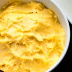 Easy Mango Frosting (Buttercream) in White Bowl.