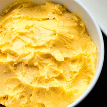 Easy Mango Frosting (Buttercream) in White Bowl.