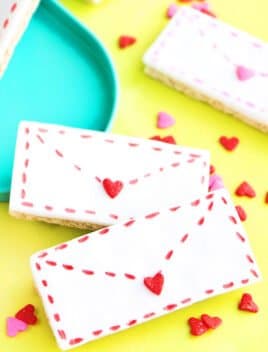Easy Valentine's Day Cookies (Love Letter Cookies) Placed on Yellow Paper with Heart Sprinkles