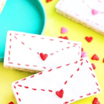 Easy Valentine's Day Cookies (Love Letter Cookies) Placed on Yellow Paper with Heart Sprinkles