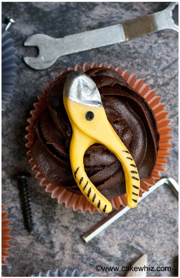 Decorated Fathers Day Cupcakes With Edible Handyman Tools on Rustic Gray Background