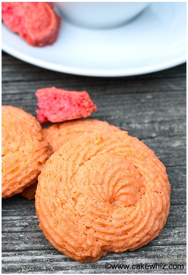 Piped Spiral Orange Cookies on Rustic Gray Background