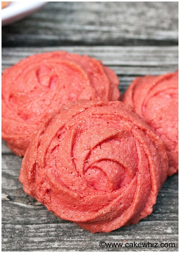 Piped Rose Raspberry Cookies on Rustic Gray Background 