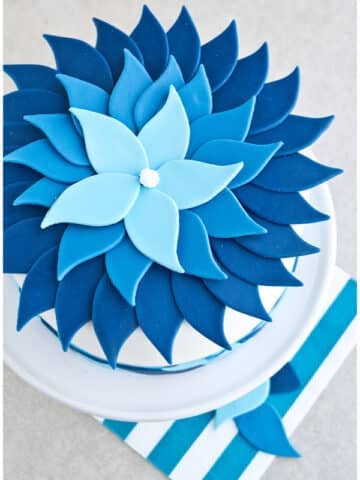 Easy Ombre Cake Decorated With Blue Fondant on Light Gray Background