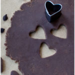 Easy Modeling Chocolate or Candy Clay Rolled Out on Table With Heart Cut Outs