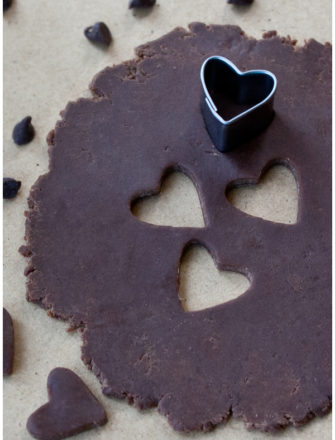 Easy Modeling Chocolate or Candy Clay Rolled Out on Table With Heart Cut Outs
