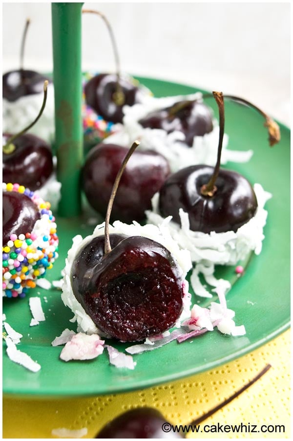 Partially Eaten Cherry With White Chocolate and Coconut on Green Dish