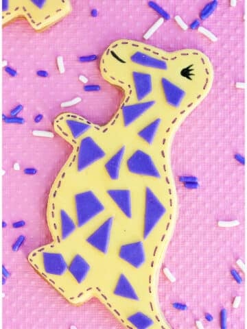 Easy Dinosaur Cookies Decorated with Fondant on Pink Background