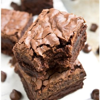 Stack of Easy Fudgy Brownies With Crackly Tops on White Dish.