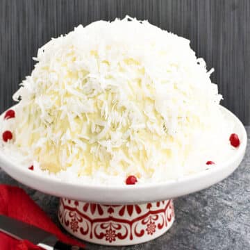 Easy Old Fashioned Chocolate Snowball Cake With Cake Mix Box on White and Red Cake Stand.