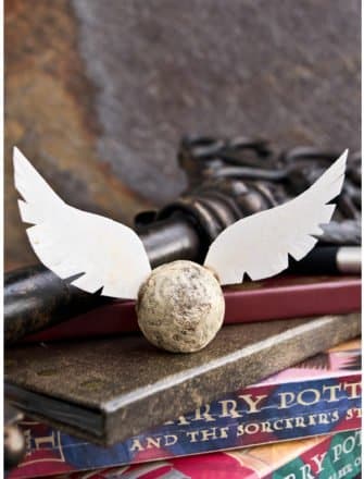 Edible DIY Harry Potter Golden Snitch Truffles on Stack of Books
