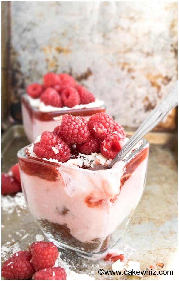 Cup of Pink Berry Mousse in Glass Cup on Rustic Background- Partially Eaten