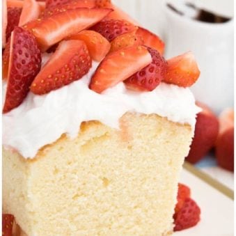 Easy Sour Cream Pound Cake With Whipped Cream and Strawberries on White Tray With Gold Rim