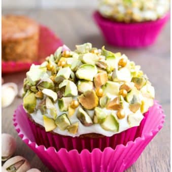 Easy Carrot Cupcakes With Cream Cheese Frosting And Pistachio Topping on Wood Background.