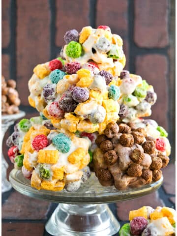 Stack of Easy Homemade Rainbow Cereal Balls on Glass Cake Stand