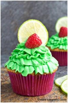 Lemon Raspberry Cupcakes in Pink Liner on Rustic Gray Background.