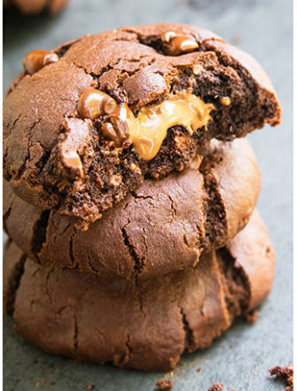 Stack of Three Triple Chocolate Cookies on Gray Background