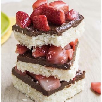 Stack of Easy Chocolate Coconut Bars on Wood Background