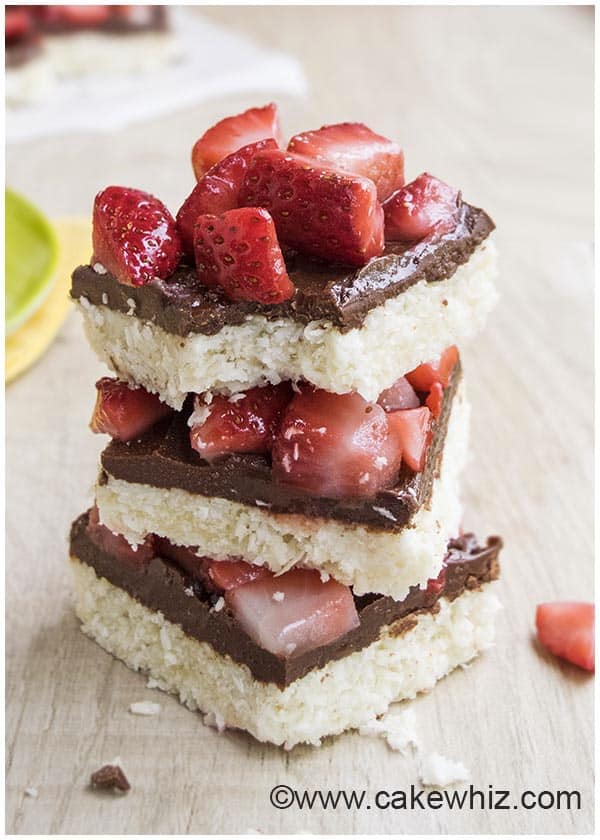 Stack of Easy Chocolate Coconut Bars on Wood Background