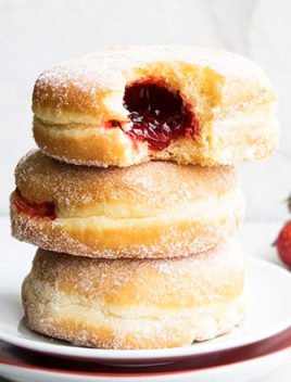 Homemade Jelly Filled Donuts (Sufganiyot) Stacked on a White Dish