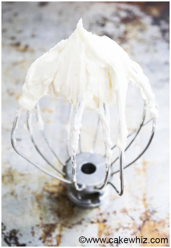 Best Cream Cheese Frosting on Whisk on Rustic Metallic Background